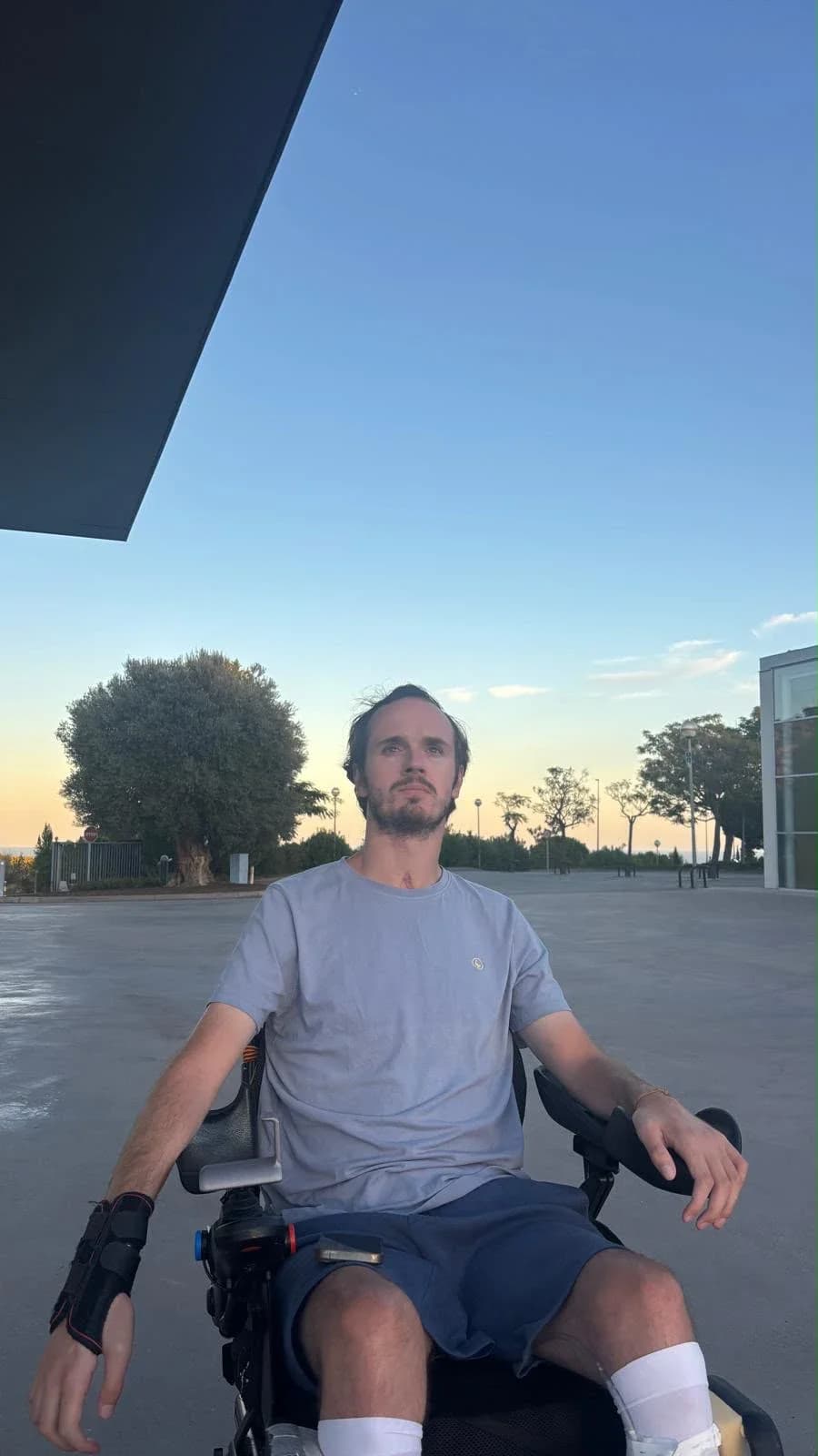 Guillermo Ucelay in his wheelchair at sunset, looking towards the horizon